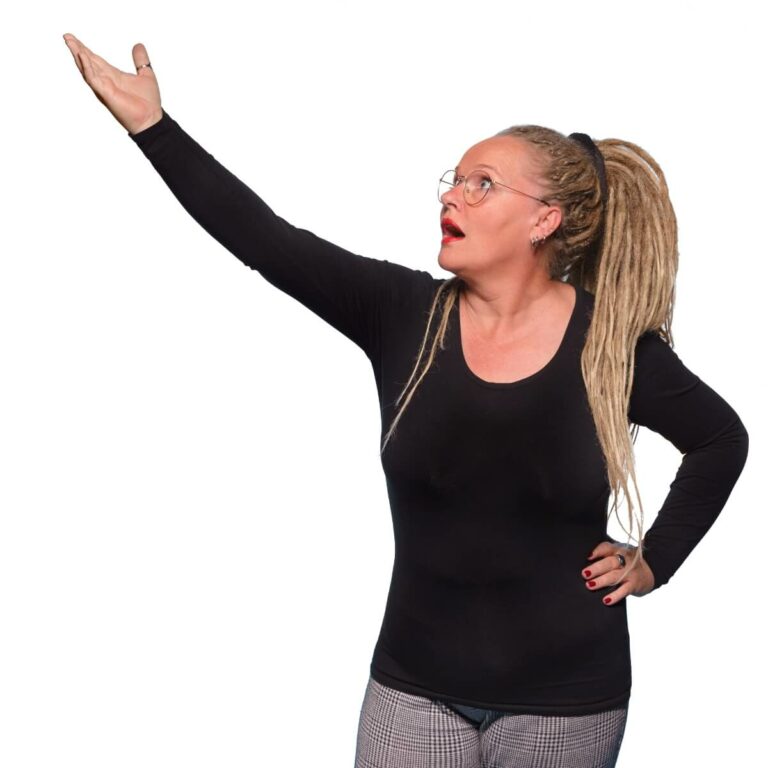Anne Bovelett, a woman with glasses and long blond hair in a big pony tail, stretches out her hand with a exasperated questioning expression on her face